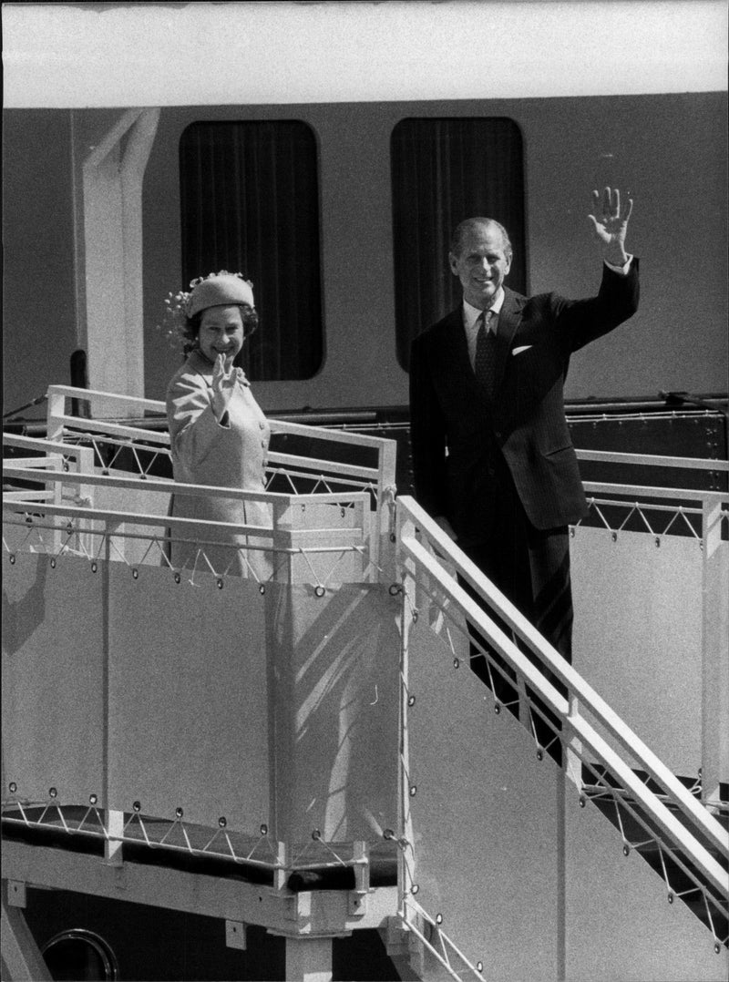 Queen Elizabeth II and Prince Philip wave smoothly from Britannia to the spectator masses at the Ranger Master Staircase - Vintage Photograph