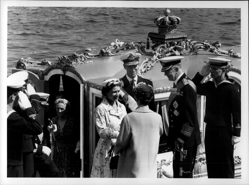 Queen Elizabeth II is greeted by Queen Louise Mountbatten and King Gustaf VI Adolf, while the rounder of the Vaasa salutes - Vintage Photograph