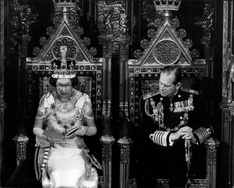 Queen Elizabeth II is speaking at the opening of parliament. By her side, Prince Philip. - Vintage Photograph