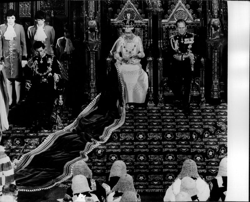 Queen Elizabeth II is speaking at the opening of parliament. By her side, Prince Philip. - Vintage Photograph