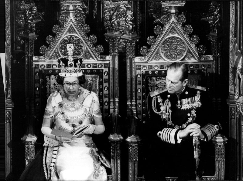 Queen Elizabeth II is speaking at the opening of parliament. By her side, Prince Philip. - Vintage Photograph