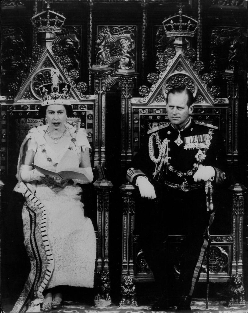 Queen Elizabeth II is speaking at the opening of parliament. By her side, Prince Philip. - Vintage Photograph