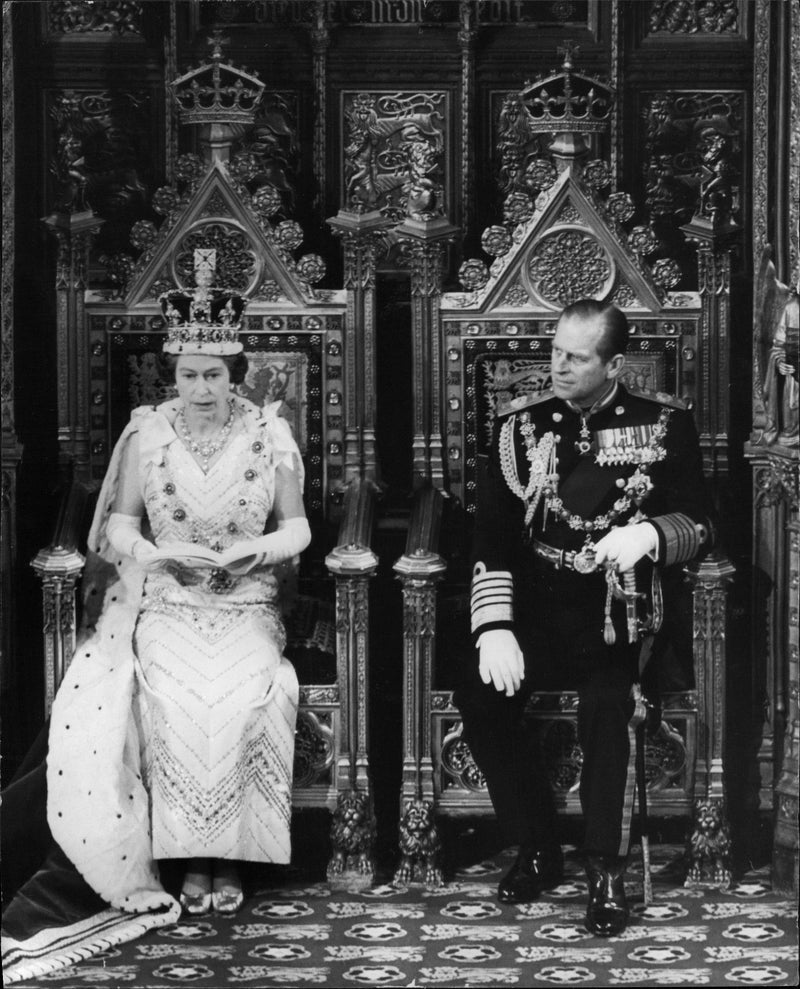 Queen Elizabeth II is speaking at the opening of parliament. By her side, Prince Philip. - Vintage Photograph