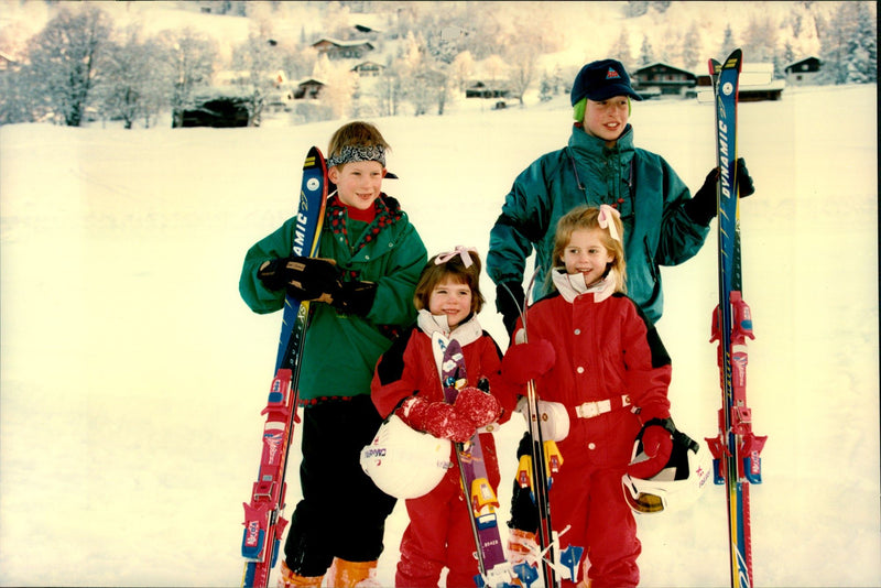 Princess sisters Beatrice and Eugenie together with the cousins ââPrince Harry and Prince William during a skiing holiday in Switzerland. - Vintage Photograph