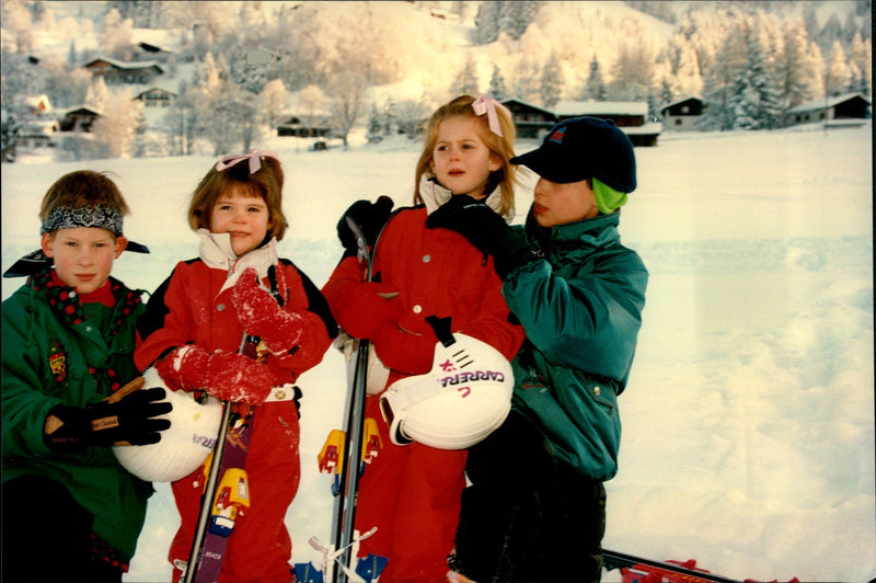 Princess sisters Beatrice and Eugenie together with the cousins ââPrince Harry and Prince William during a skiing holiday in Switzerland. - Vintage Photograph