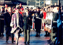 Queen Margrethe inspects the guard at the town hall square. Behind her is Prince Henry. - Vintage Photograph
