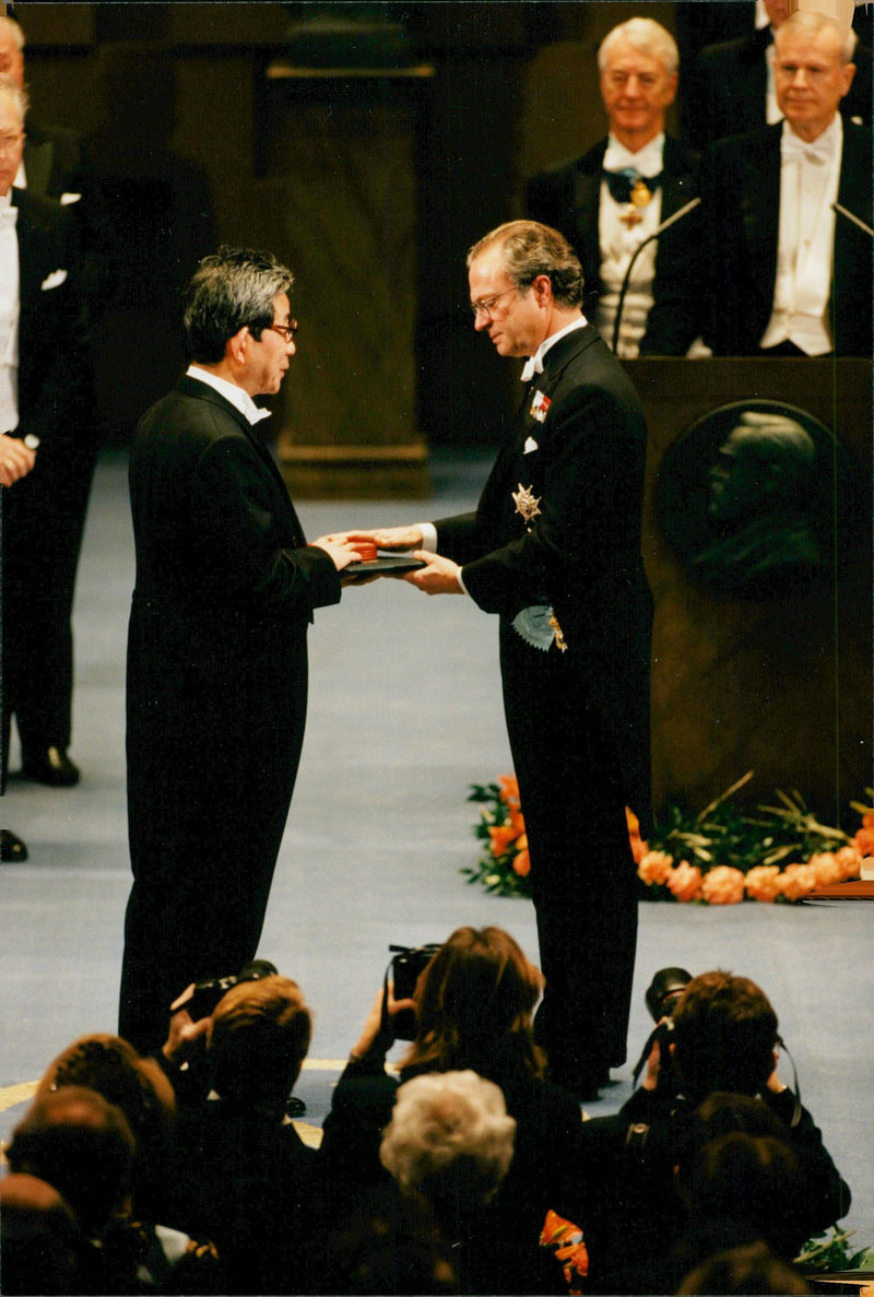Kenzaburo Oe receives the Nobel Prize in Literature by King Carl XVI Gustaf in the Concert Hall. - Vintage Photograph