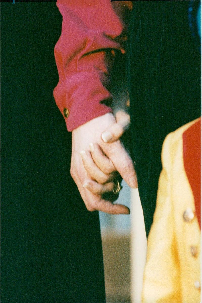 Newlywed couple Michael Jackson and Lisa Marie Presley hold hands when they leave Bethesda Hospital after visiting a sick boy - Vintage Photograph