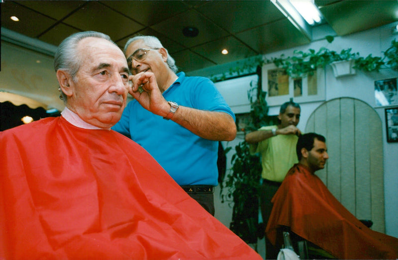 Israeli politician Shimon Peres is with the hairdresser. - Vintage Photograph