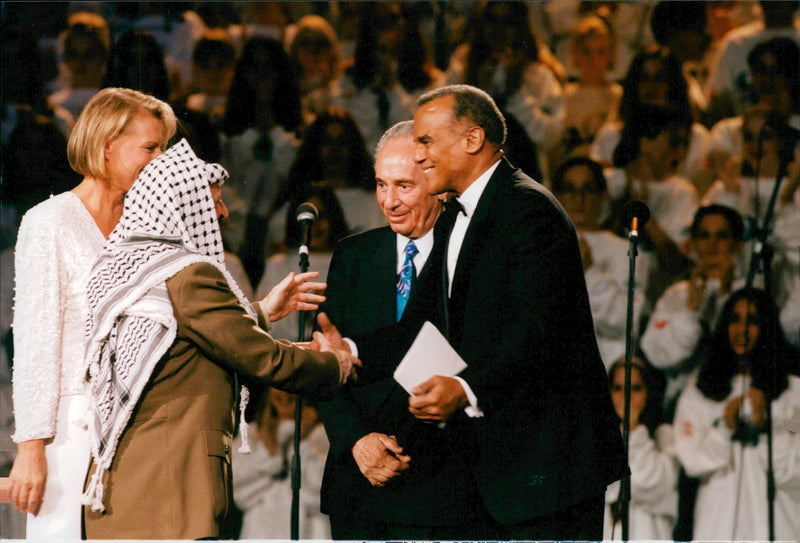 Israels politician Shimon Peres is greeted by Harry Belafonte and Arja Saijonmaa during the UNESCO charity gala in Oslo Spektrum. - Vintage Photograph