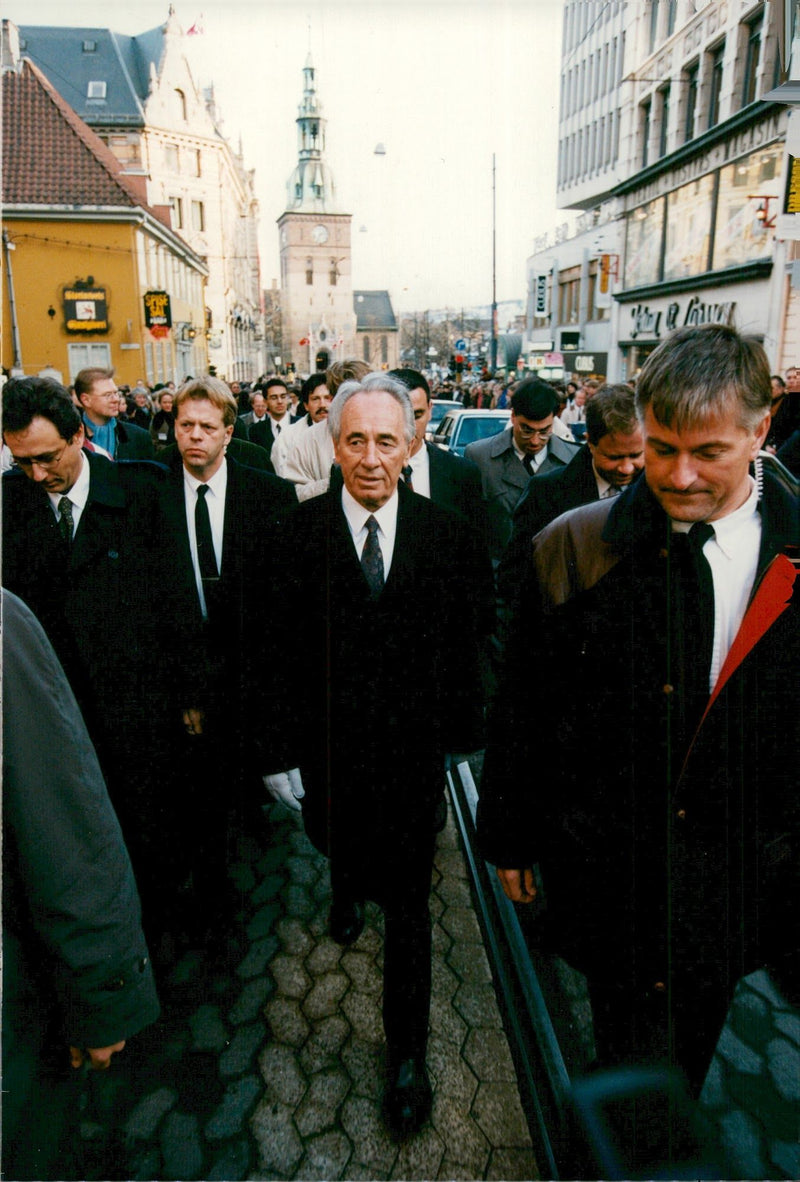 Israels politician Shimon Pere walks the longest streets along with delegates. - Vintage Photograph