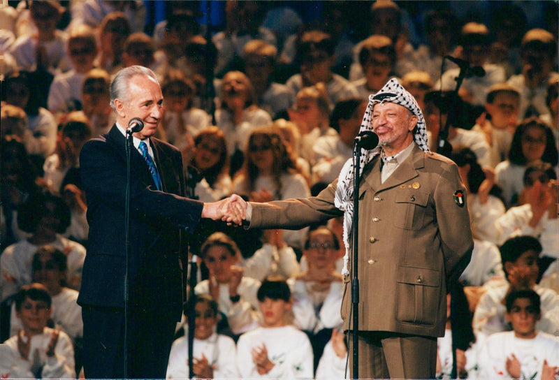 Israeli politician Shimon Peres with Yasser Arafat during a charity gala in Oslo Spektrum. - Vintage Photograph