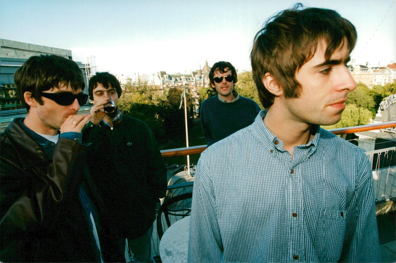 The Oasis Rock Group enjoys a nice drink on the terrace. - Vintage Photograph