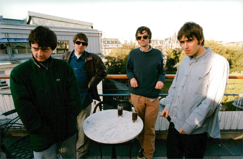 The Oasis Rock Group enjoys a nice drink on the terrace. - Vintage Photograph