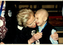 Katharine, the Duchess of Kent, hugs about a little boy to undergo a transplant. - Vintage Photograph