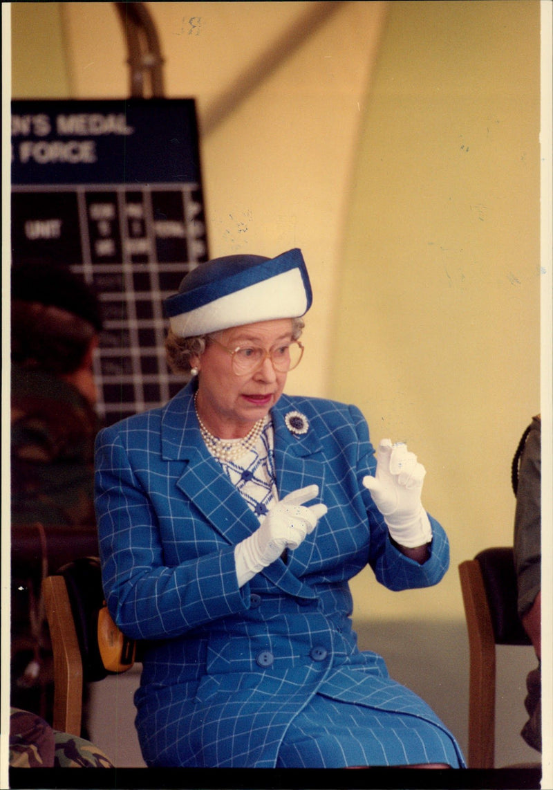 Queen Elizabeth II in the audience during a military show. - Vintage Photograph