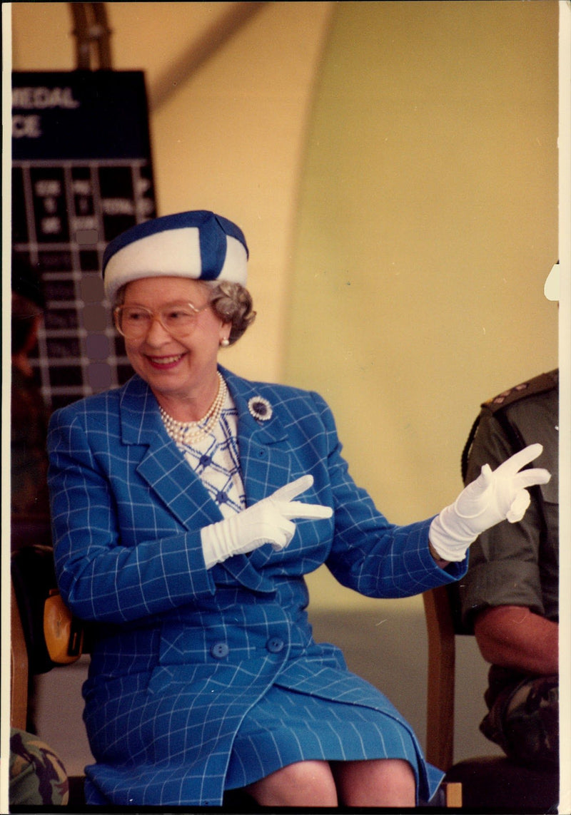 Queen Elizabeth II in the audience during a military show. - Vintage Photograph