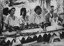 Queen Elizabeth and Prince Philip under the Welcome Bank on Tonga Islands. Prin Philip in conversation with Queen Salote - Vintage Photograph
