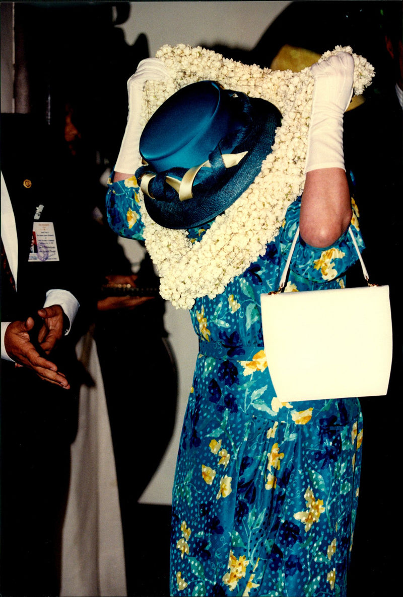 Queen Elizabeth II takes off her shawl when she arrives at Untouchable at Christian Aid Center. - Vintage Photograph