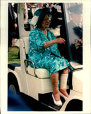 Queen Elizabeth takes a golf car on her way to an event. - Vintage Photograph
