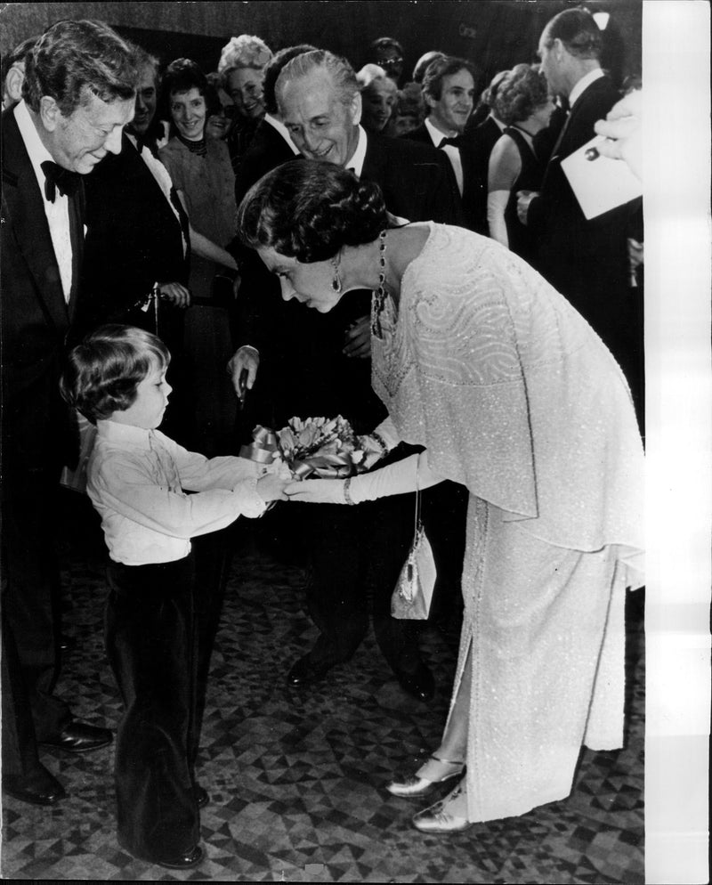 Queen Elizabeth II receives a bouquet of flowers by a little boy. - Vintage Photograph