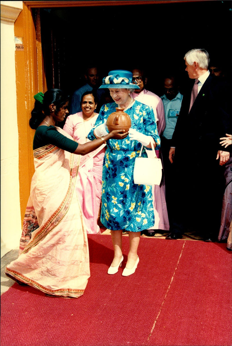 Queen Elizabeth II receives a gift from a fool while visiting Kochi - Vintage Photograph