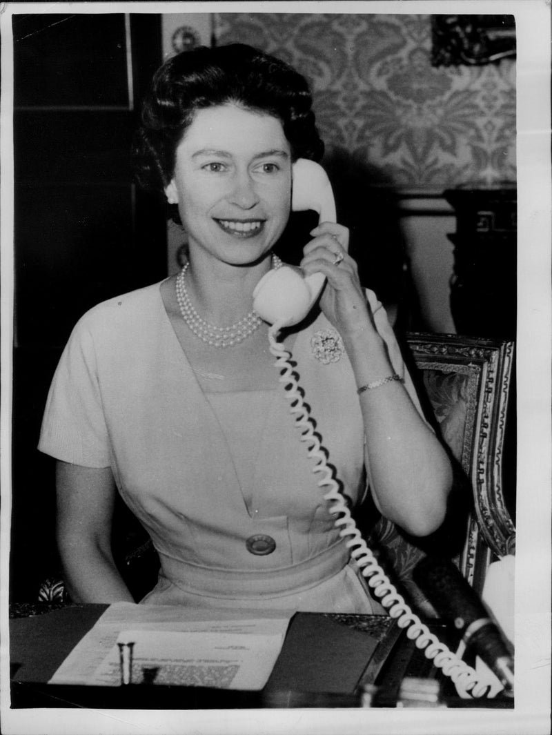 Queen Elizabeth II speaking to the Prime Minister of Canada over the telephone when she inaugurated the CANTAT telephone cable - Vintage Photograph