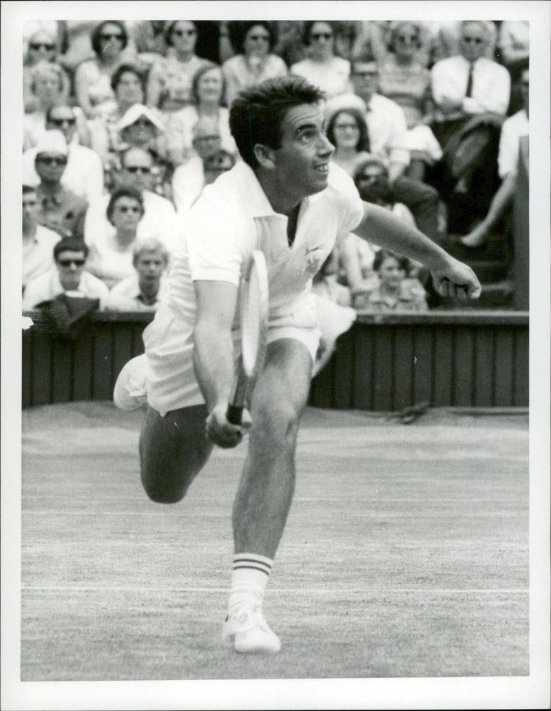 Action shot of Manuel Santana taken in conjunction with the Wimbledon tournament. - Vintage Photograph