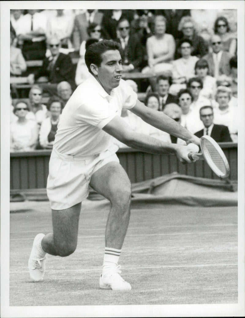 Action shot of Manuel Santana taken in conjunction with the Wimbledon tournament. - Vintage Photograph