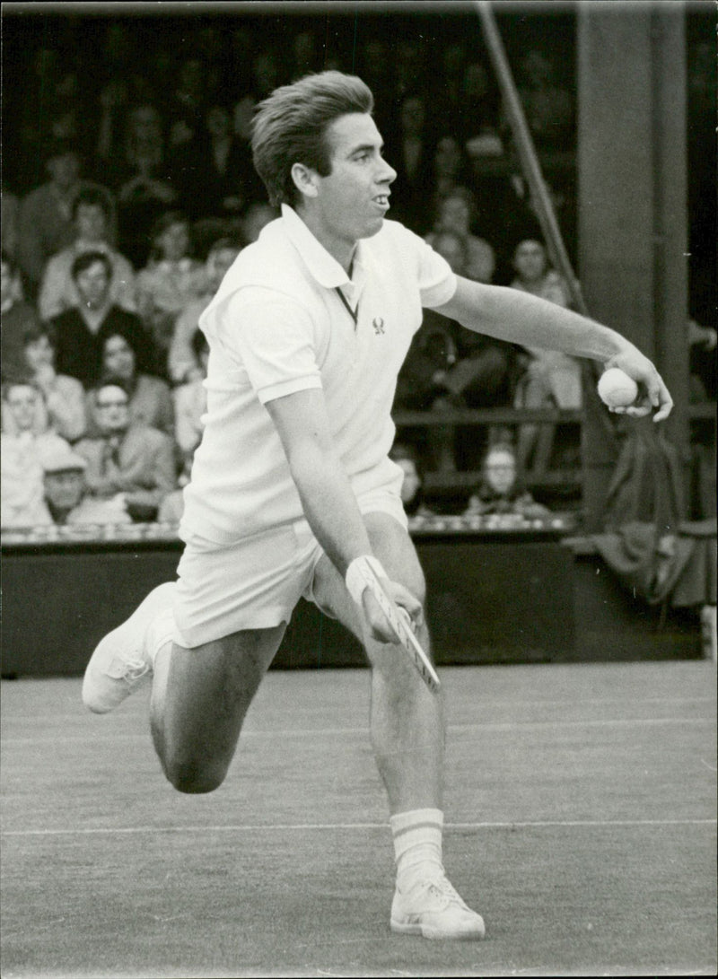 Action shot of Manuel Santana taken in conjunction with the Wimbledon tournament. - Vintage Photograph