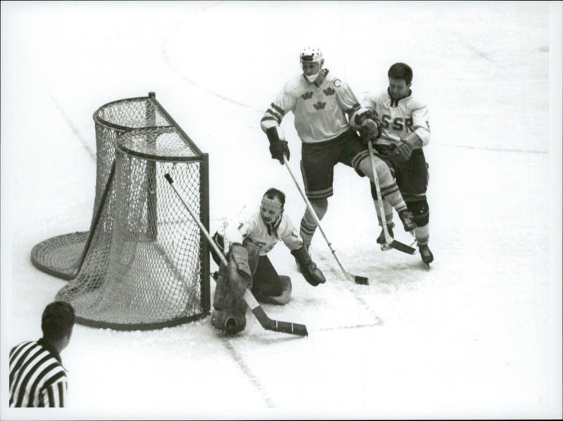 Ice hockey player Sven Tumba down at the goal of the ice hockey match Sweden-CSSR during the Winter Olympics in Innsbruck in 1964 - Vintage Photograph
