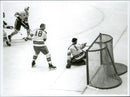 Ice hockey player Sven Tumba down at the goal of the ice hockey match Sweden-CSSR during the Winter Olympics in Innsbruck in 1964 - Vintage Photograph