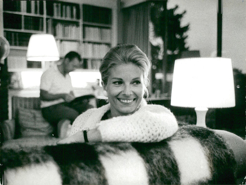 Gunnel Lindblom takes it easy at home after the premiere of Gamlinfilmen. Create Dr. Sture Helander in the backround. - Vintage Photograph