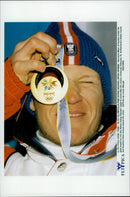 Austrian skier Hermann Maier holds up his gold medal as he won in Super-G during the Winter Olympics 1998 - Vintage Photograph