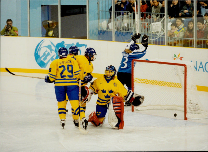 Finnish Hanna-Riika Niemiinen celebrates after breaking the puck behind Swedish goalkeeper Annica AhlÃ©n. Finland won by 6-0. - Vintage Photograph