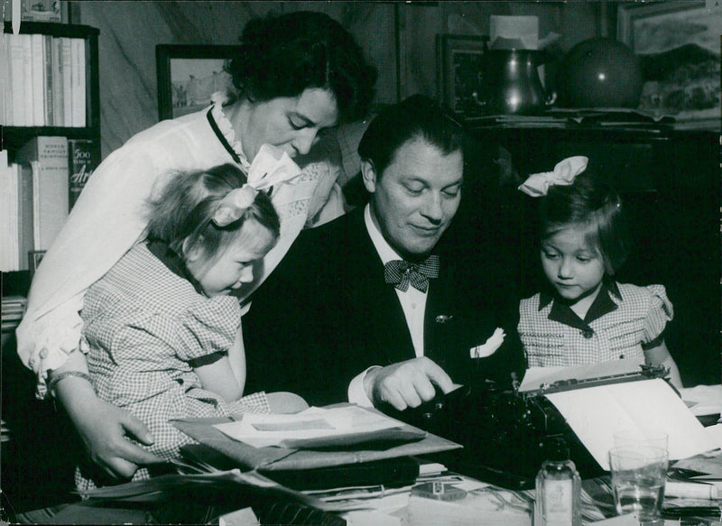 The author Harry Martinson at his typewriter together with his wife Ingrid and the children Harriet and Eve - 18 March 1949 - Vintage Photograph
