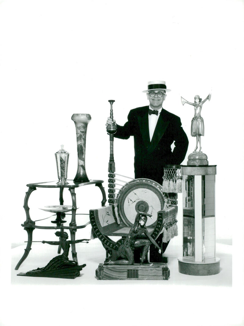 The great collector Elton John with some of his animals. In front of him a chair of Carlo Bugatti and a dance of ivory and bronze of Chiparus - Vintage Photograph
