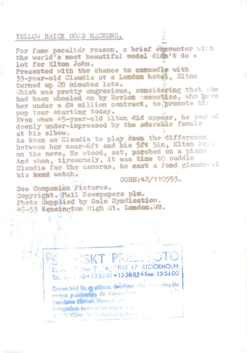 Elton John along with Claudia Schiffer during a charity event. - Vintage Photograph