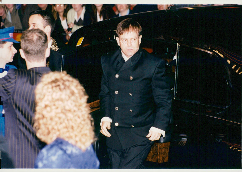 Elton John arrives at the premiere of Disney blockbuster. - Vintage Photograph