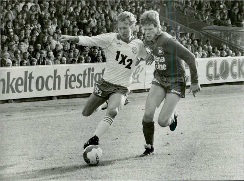 Football player from Ãrgryte tries to take the ball from the opponent during a match - Vintage Photograph