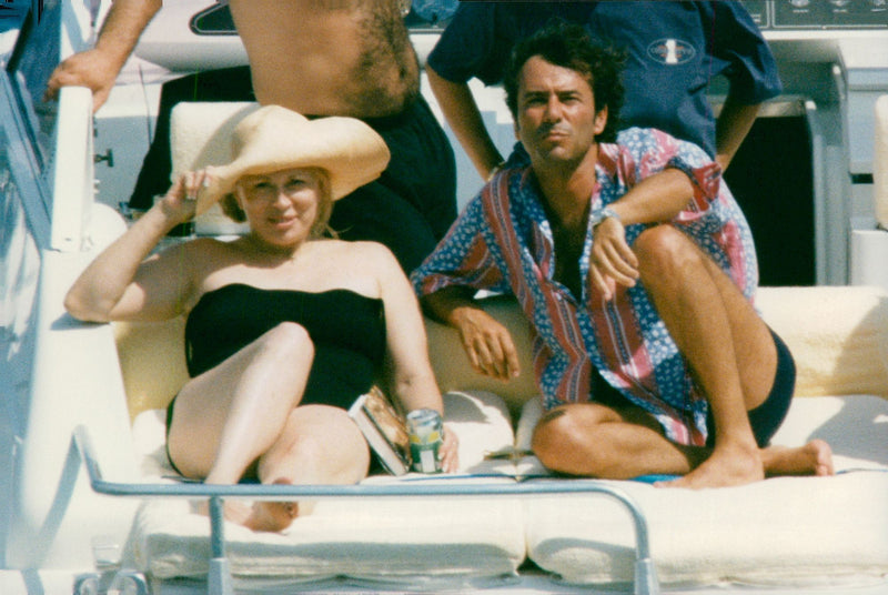 Faye Dunaway along with Bernard Montiel aboard a yacht on the French Riviera. - Vintage Photograph