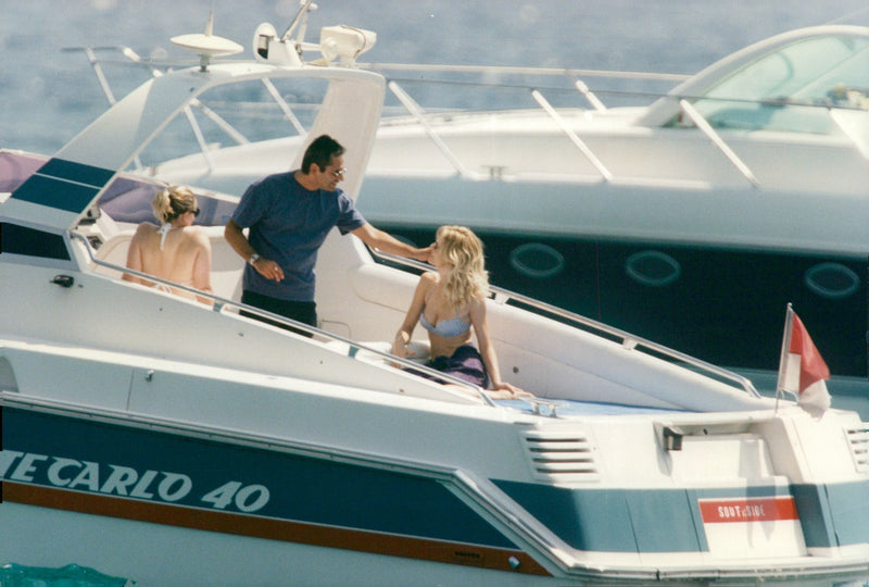 The supermodel Karen Mulder sits with her boyfriend Jean Yves Le Fur - Vintage Photograph