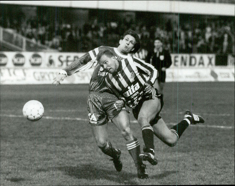 DjurgÃ¥rdens football player Mikael Martinsson in close combat during a match. - Vintage Photograph