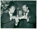 Kirk Douglas handed a viking ship to the Duke of Edinburgh during the premiere of the movie Vikingsna in London - Vintage Photograph