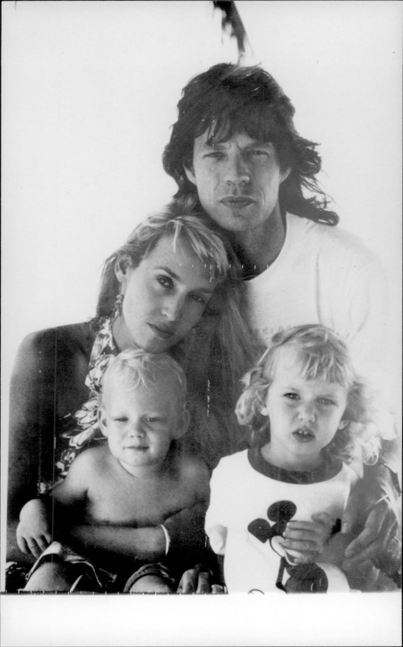 Mick Jagger and the model Jerry Hall with their children Elizabeth Scarlet and James Leroy on the beach at Fryers Well - Vintage Photograph