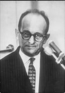 Nazi Adolf Eichmann photographed during the trial in Jerusalem where he was convicted of the death of war crimes and massacres during WWII. - Vintage Photograph
