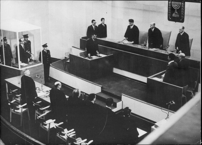 Adolf Eichmann during the trial in Jerusalem where he was sentenced to death for war crimes and massacre during WWII, in bulletproof glass cage. - Vintage Photograph