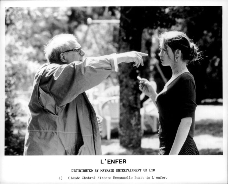 Actress  Emmanuelle Beart in a movie Hell, a 2005 film.  She is being directed on what to do in the scene. - Vintage Photograph