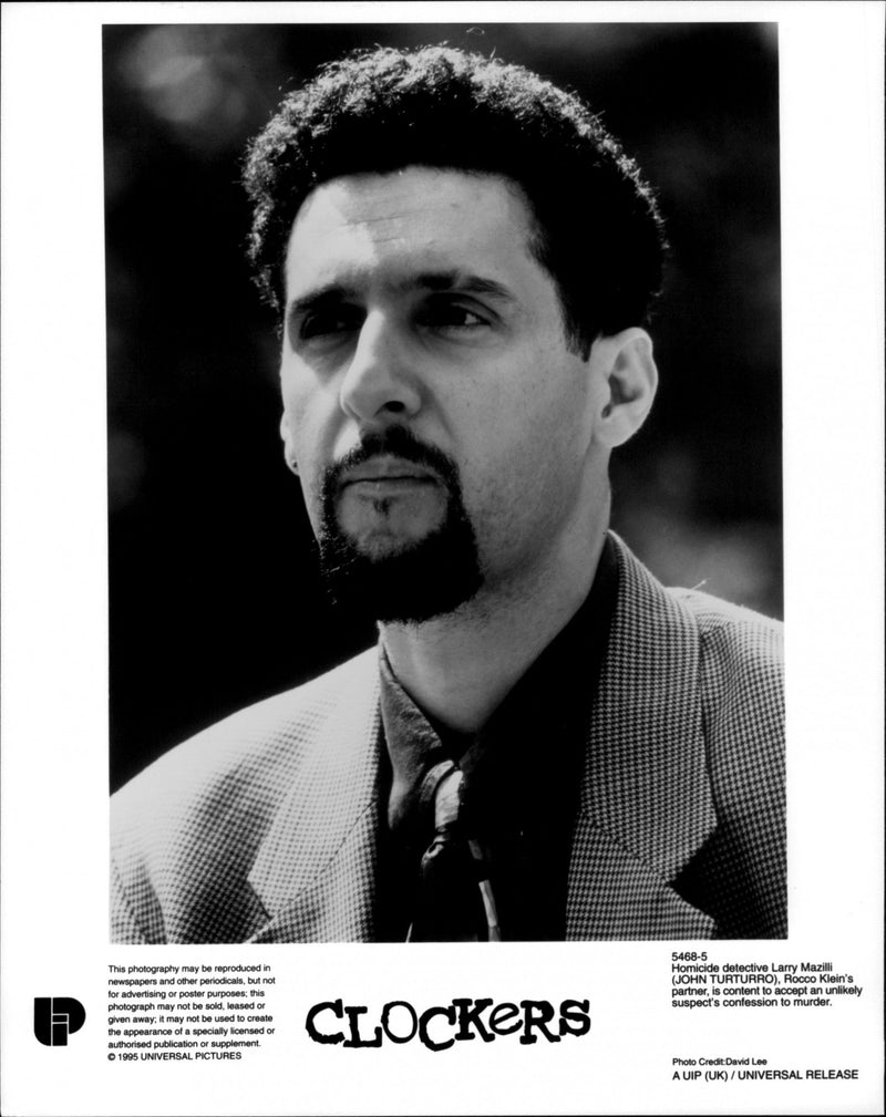 Homicide detective Larry Mazilli (John Turturro), Rocco Klein partner, is content to accept an unlikely suspect's confession to murder. - Vintage Photograph