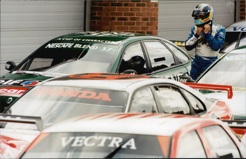 Rickard Rydell leaves his Volvo among the other BTCC cars in the warehouse of Brands Hatch. - Vintage Photograph
